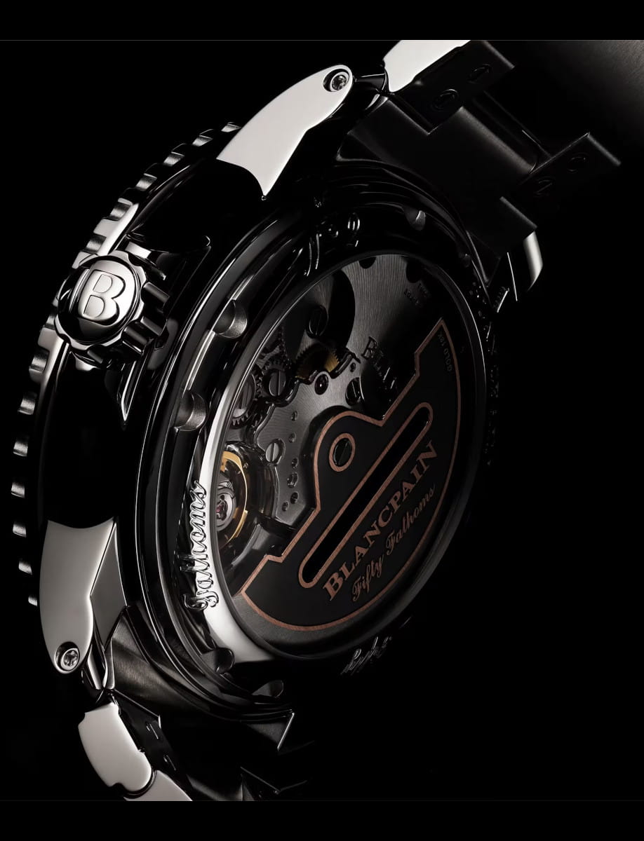 Side view of Blancpain Fifty Fathoms Automatique wristwatch with stainless steel case, open case back, and rubber strap.