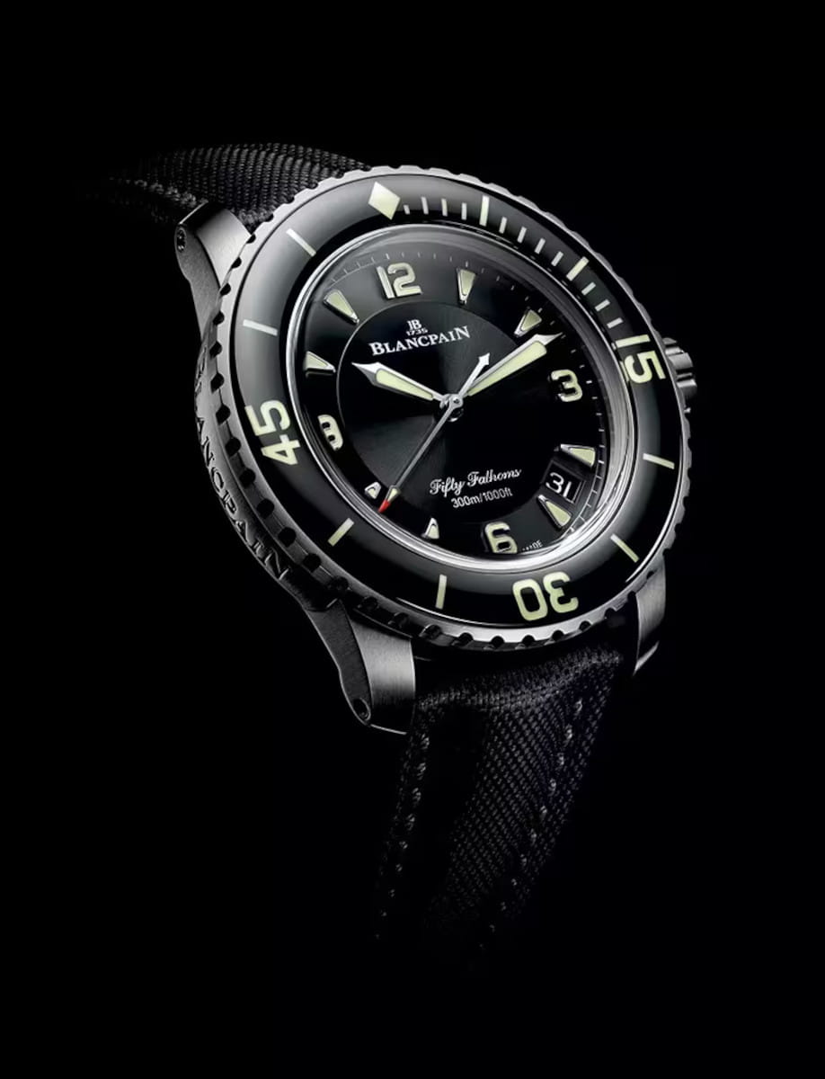Side view of Blancpain Fifty Fanthoms Automatique wristwatch with titanium case, sunburst black dial, and sail-canvas rubber strap.