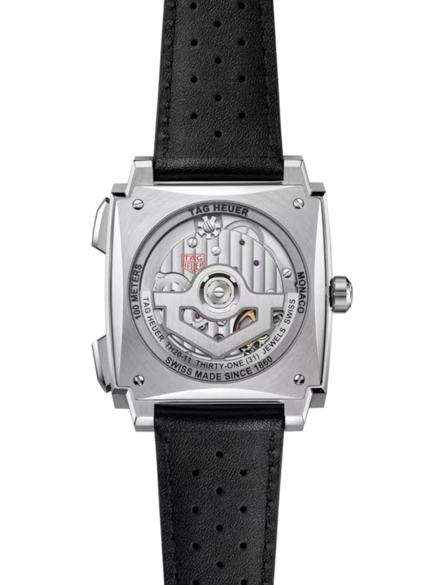 Back view of Tag Heuer Monaco Chronograph wristwatch with titanium case, open case back, and black leather strap.