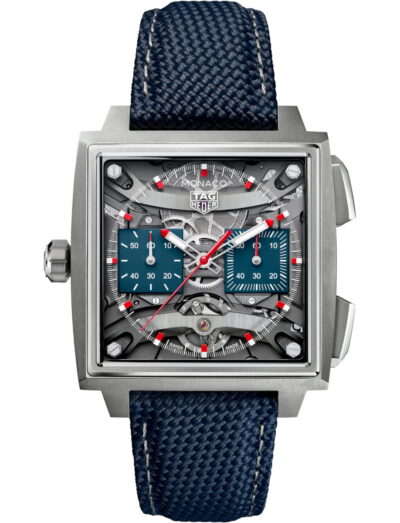 Tag Heuer Monaco Evergraph wristwatch with titanium case, transparent dial, and blue rubber strap.
