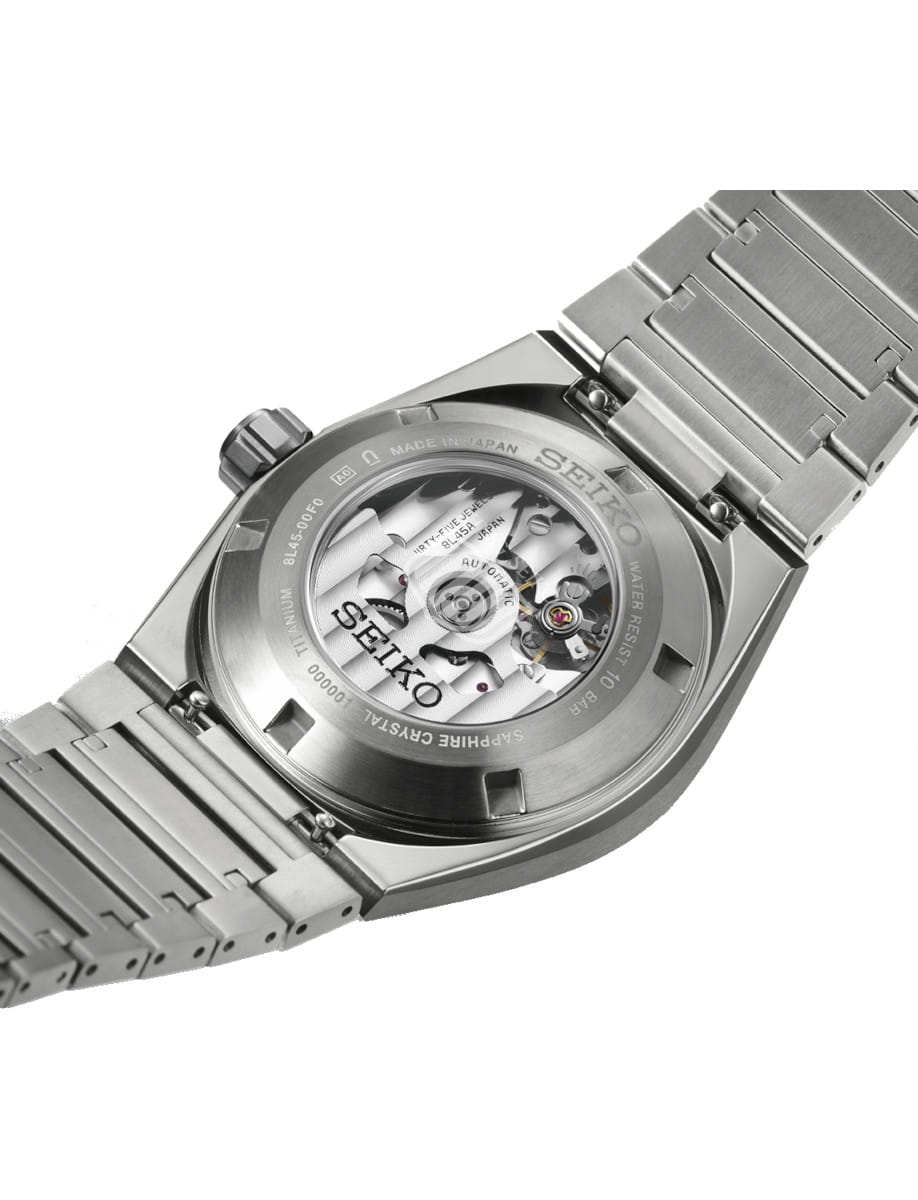 Back view of Seiko wristwatch with titanium case and bracelet, and open case back.