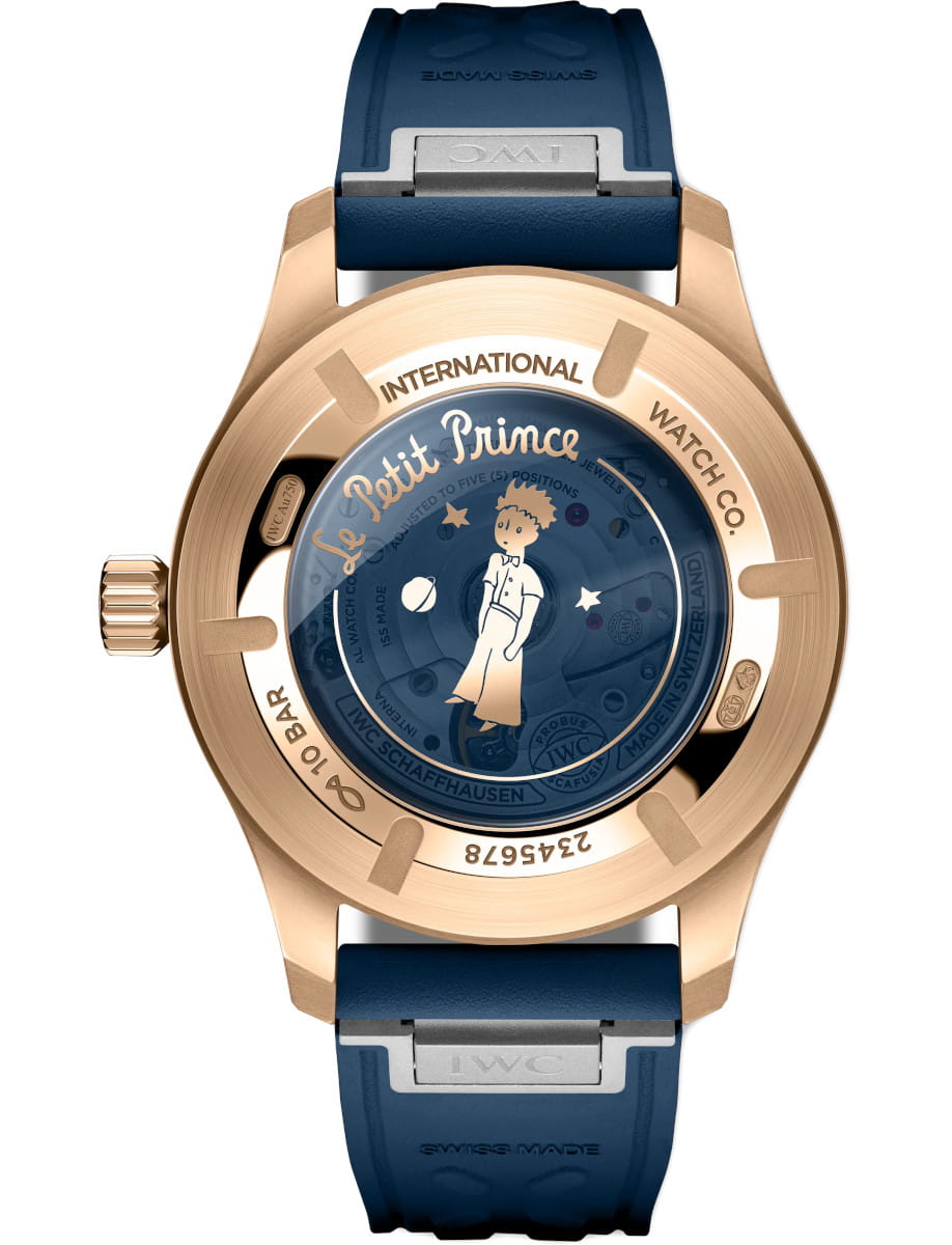 Back view of IWC Pilot's Watch Mark XX Le Petit Prince wristwatch with 18k 5N gold case, synthetic sapphire crystal caseback, and blue rubber strap.