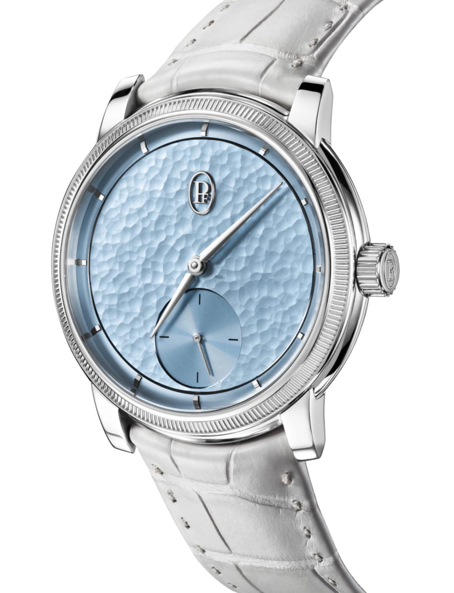 Side view of Parmigiani Fleurier Toric Petite Seconde wristwatch with 950 Platinum case, Morning Blue dial, and alligator leather strap.