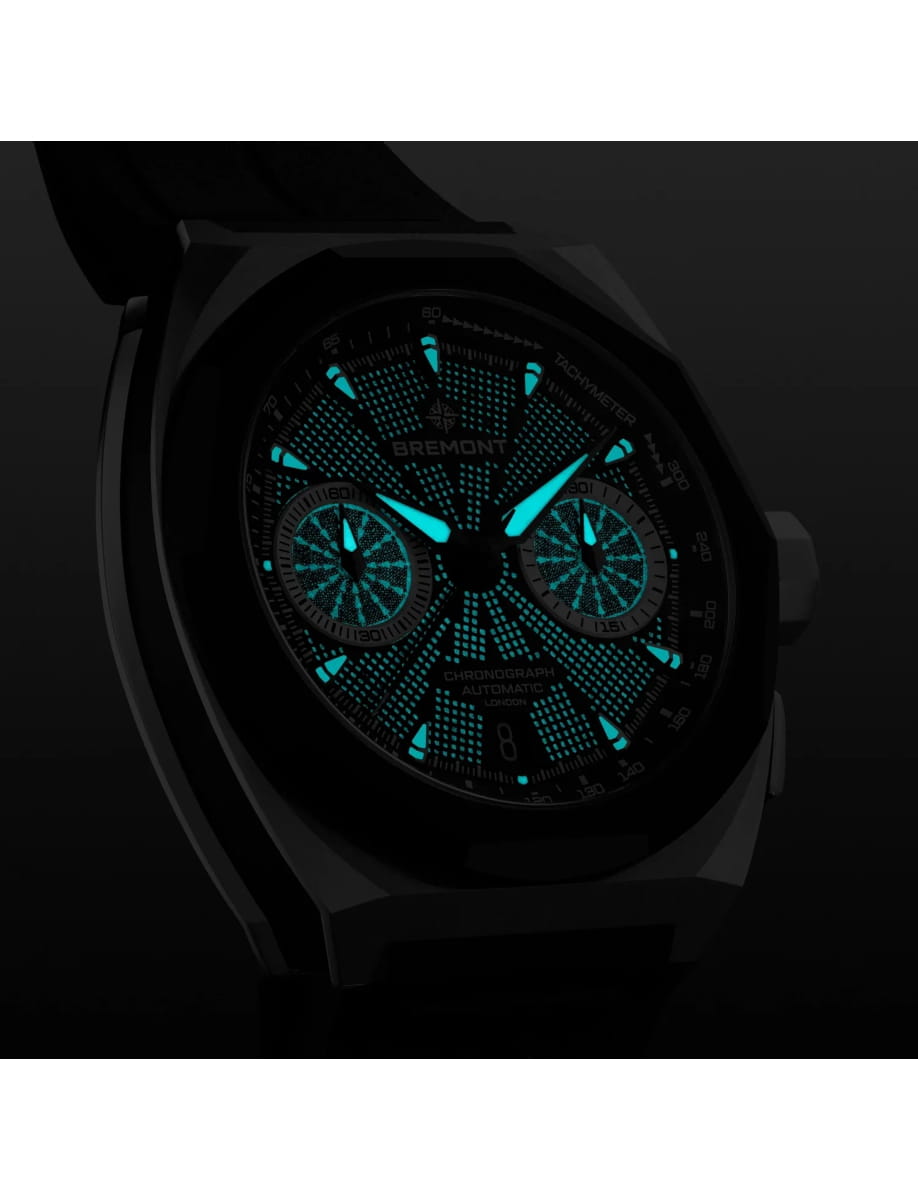 Night view of Bremont wristwatch with stainless steel case, black dial and black rubber strap