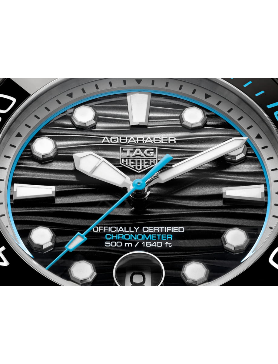 Close view of Tag Heuer Aquaracer Professional 500 Date wristwatch with titanium case and bracelet, and black and blue dial.
