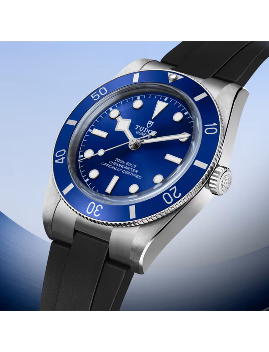 Side view of Tudor wristwatch with stainless steel case, blue dial and black rubber strap