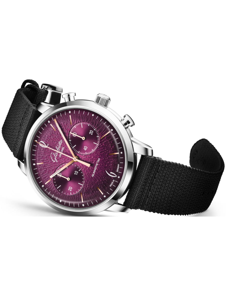 Side view of Glashutte Original wristwatch with stainless steel case, purple dial and black synthetic fabric strap