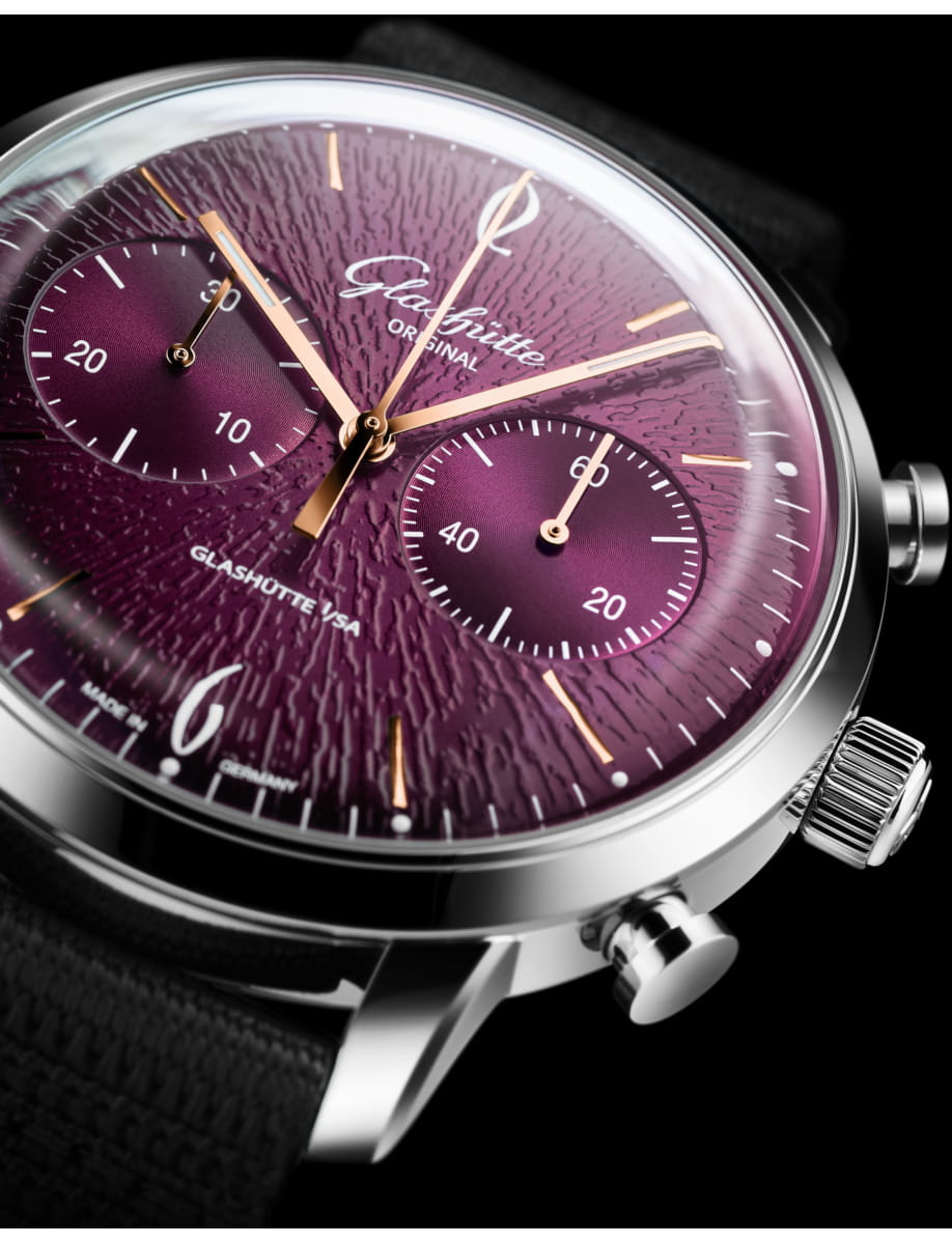 Closer view of Glashutte Original wristwatch with stainless steel case, purple dial and black synthetic fabric strap