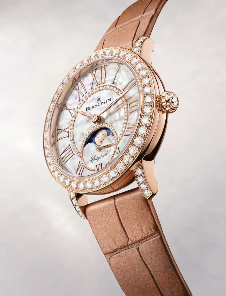 Side view of Blancpain Ladybird Colors Phases de Lune wristwatch with red gold case, Mother-of-pearl set with diamonds dial, and alligator leather strap.