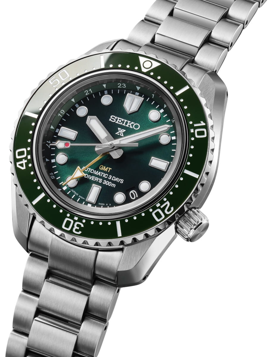 Side view of Seiko Prospex wristwatch with stainless steel case and bracelet, and green dial.