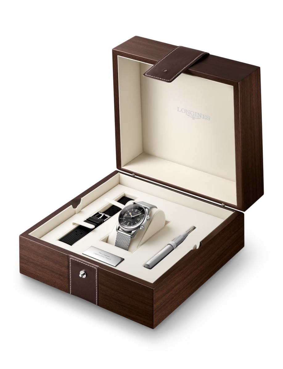 Box view of Longines Legend Diver 59 wristwatch with stainless steel case and bracelet, and black grained dial.