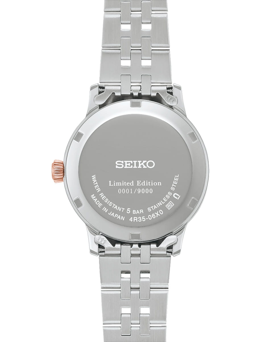 Back view of Seiko Presage Cocktail Time wristwatch with stainless steel case and bracelet, and pink mother of pearl dial.