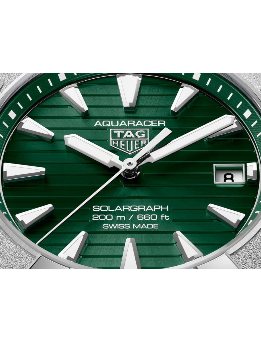 Close view of TAG Heuer wristwatch with stainless steel case and bracelet and green dial