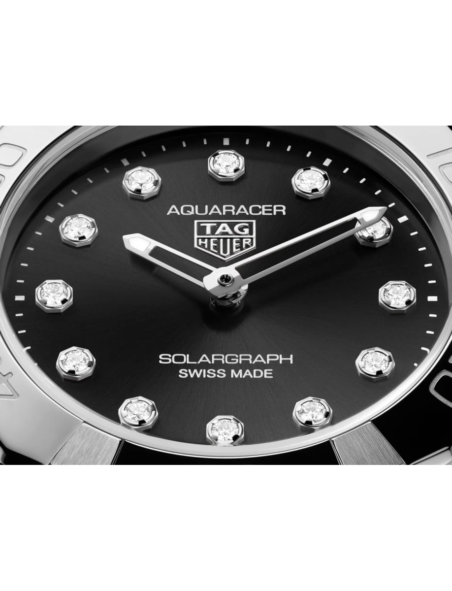 Close view of TAG Heuer wristwatch with stainless steel case and bracelet and black dial
