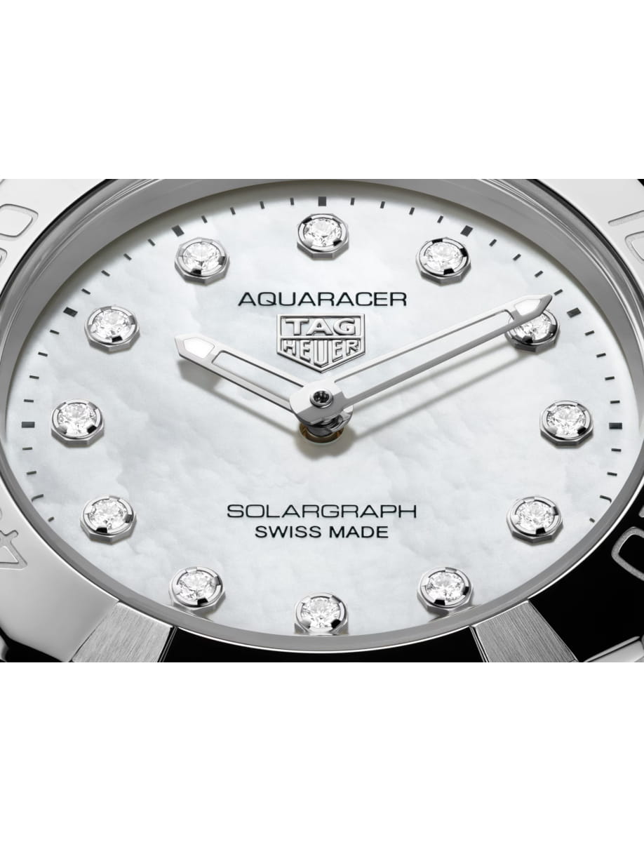 Close view of TAG Heuer wristwatch with stainless steel case and bracelet and white dial