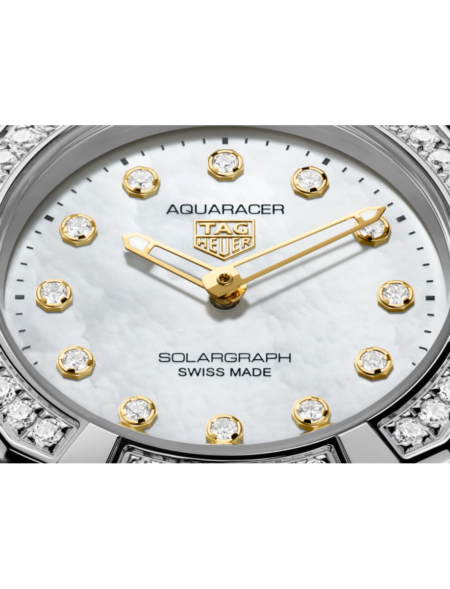 Close view of TAG Heuer wristwatch with stainless steel case and bracelet and white dial