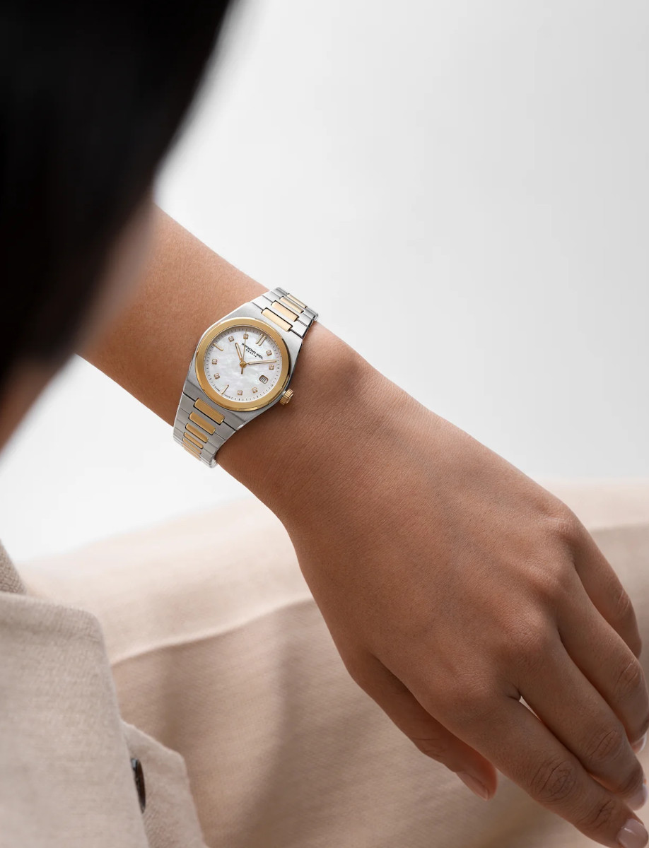 Lifestyle image of Raymond Weil A.R.T. wristwatch with stainless steel with yellow gold PVD plating, and white mother-of-pearl dial.