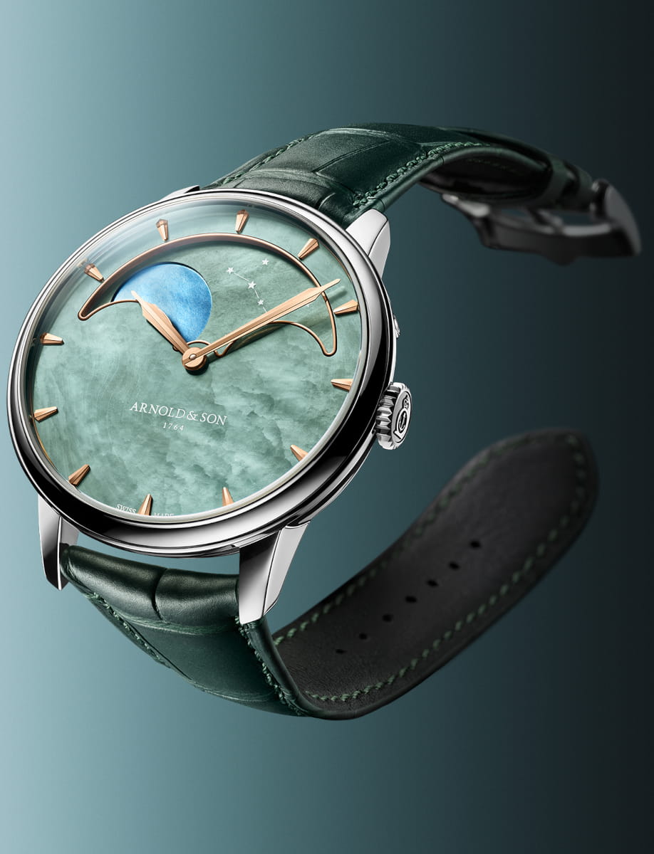 Side view of Arnold&Son Perpetual Moon wristwatch with stainless steel case, green dial, and green alligator leather.