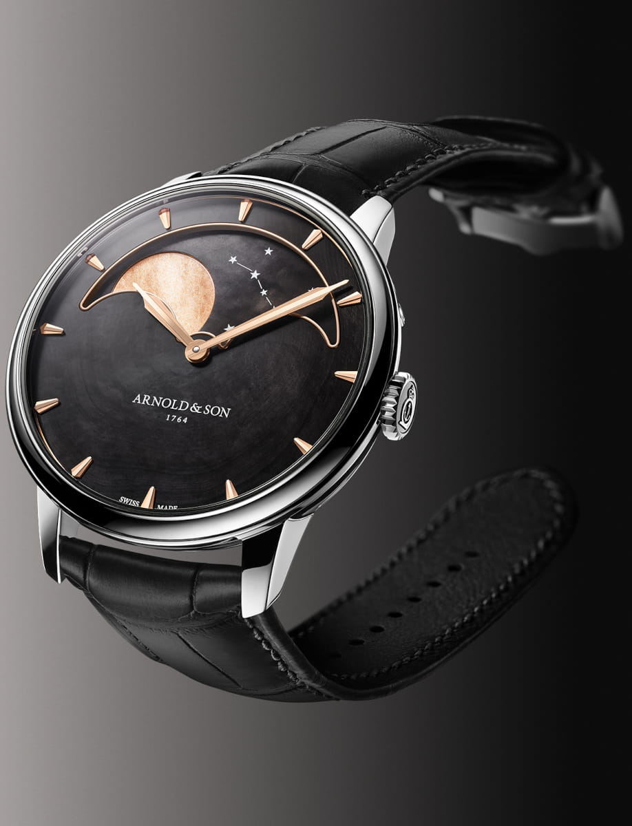 Side view of Arnold&Son Perpetual Moon wristwatch with stainless steel case, black dial, and black alligator leather.