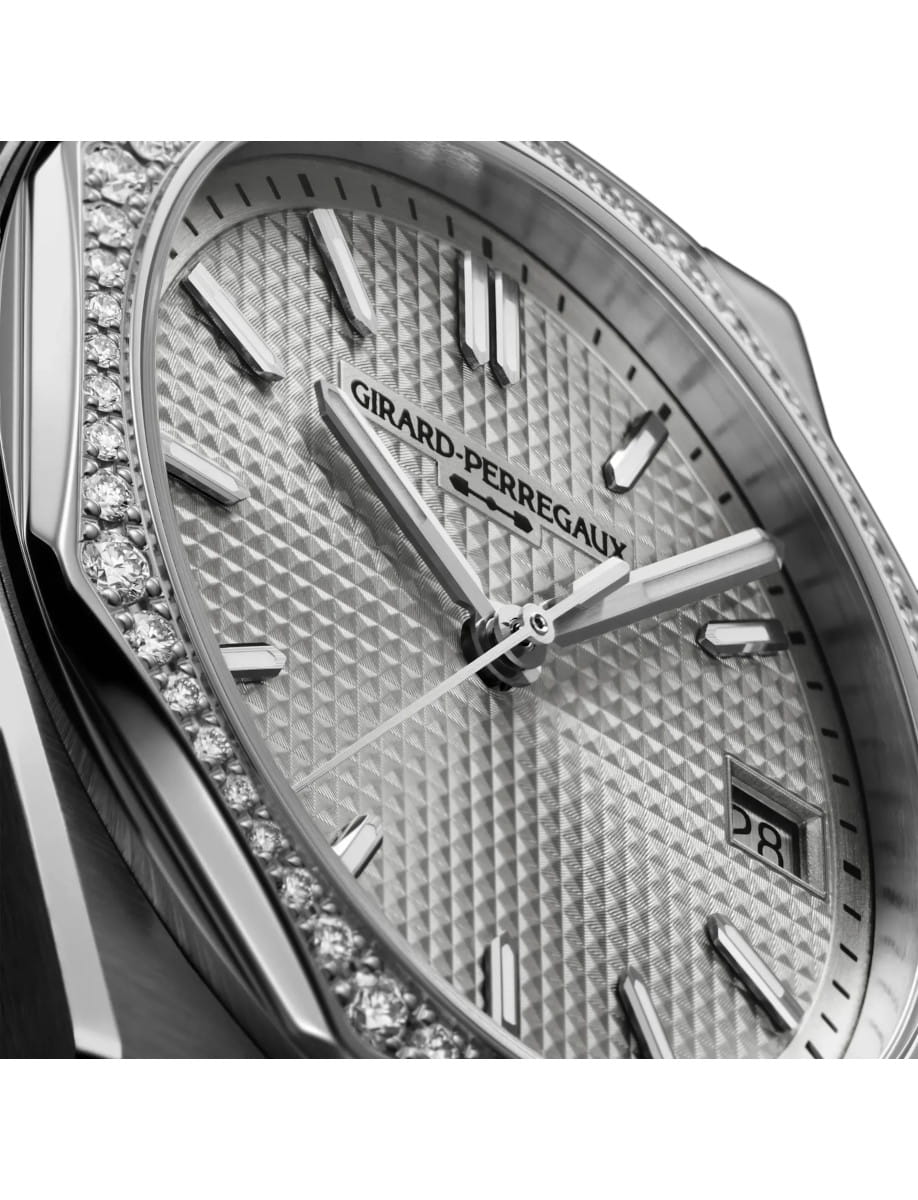 Side view of Girard Perregaux Laureato Fifty 36mm wristwatch with stainless steel case with diamond bezel and steel bracelet, and silver-toned dial.
