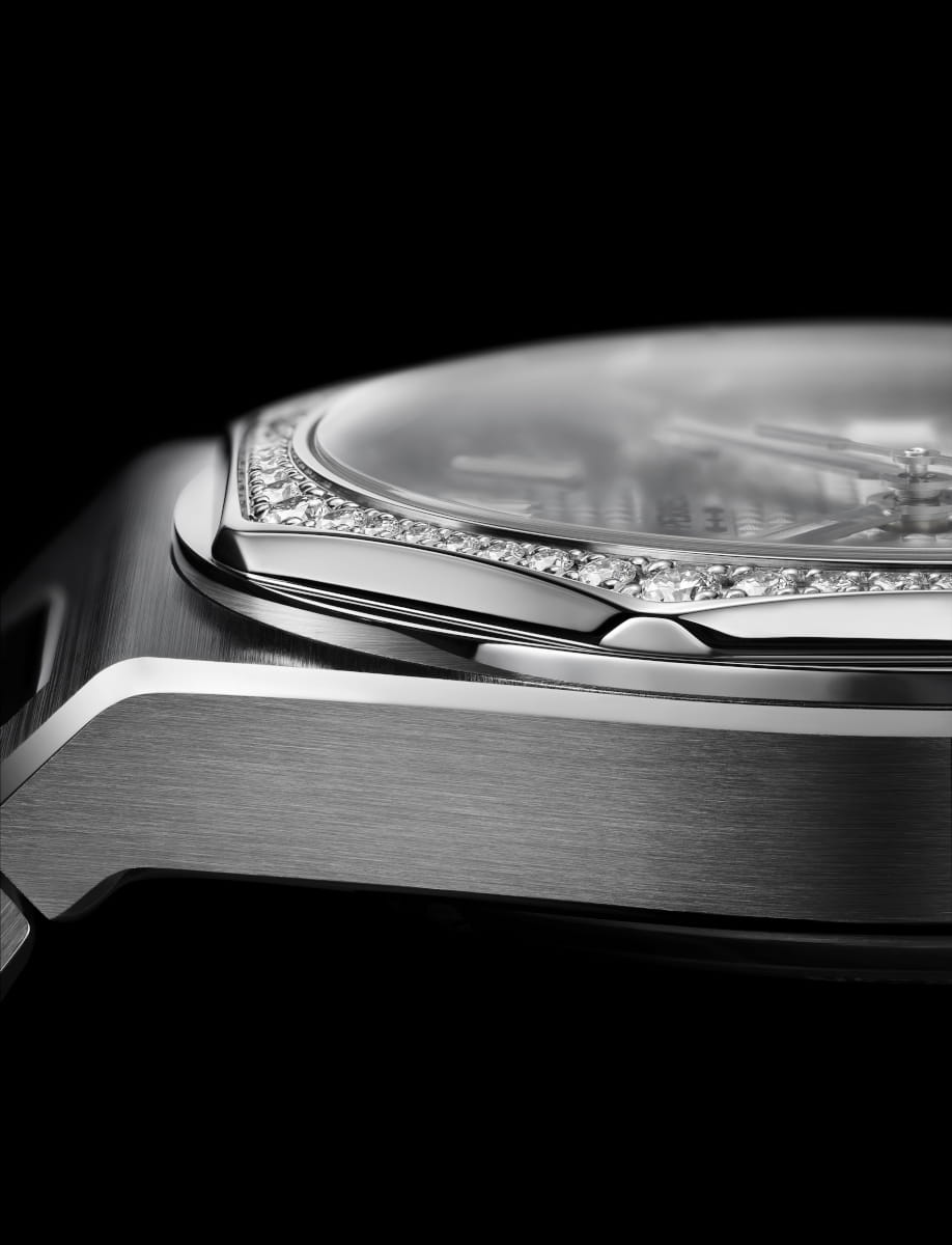 Side view of Girard Perregaux Laureato Fifty 36mm wristwatch with stainless steel case with diamond bezel and steel bracelet, and silver-toned dial.