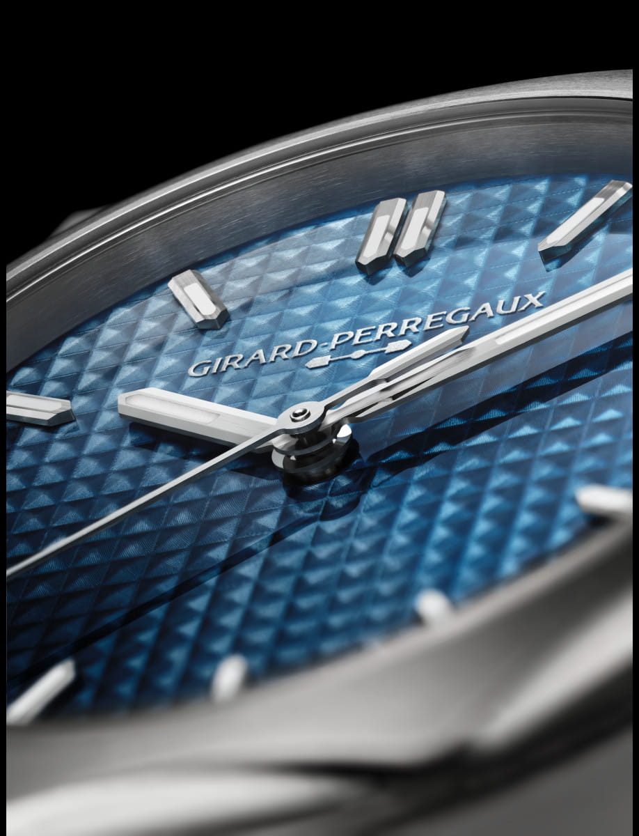 Close view of Girard Perregaux Laureato Fifty wristwatch with stainless steel case and bracelet, and blue dial.