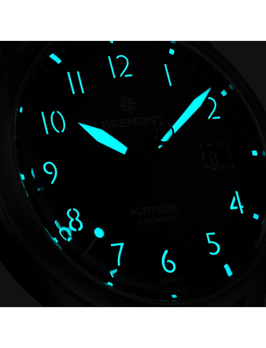 Night view of Bremont wristwatch with stainless steel case, blue dial, blue rubber and leather strap