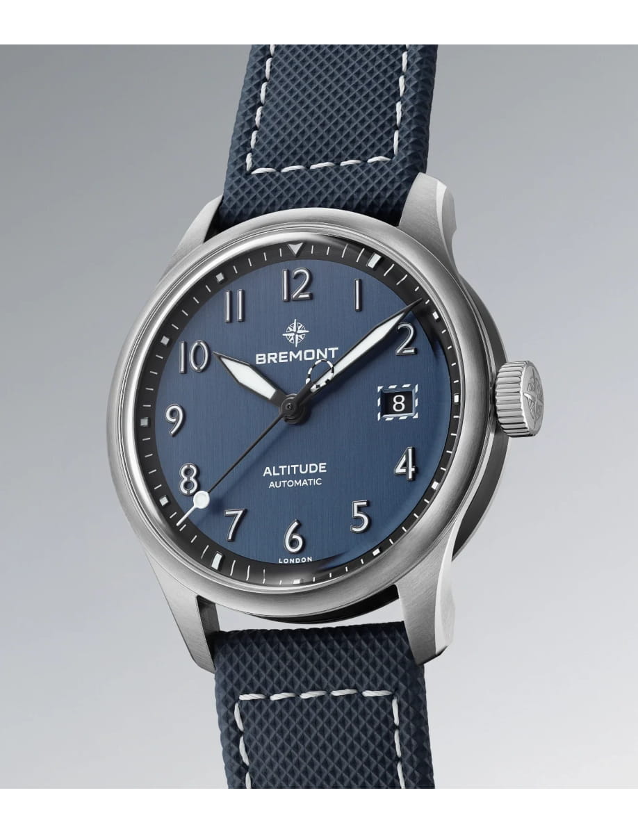 Side view of Bremont wristwatch with stainless steel case, blue dial, blue rubber and leather strap
