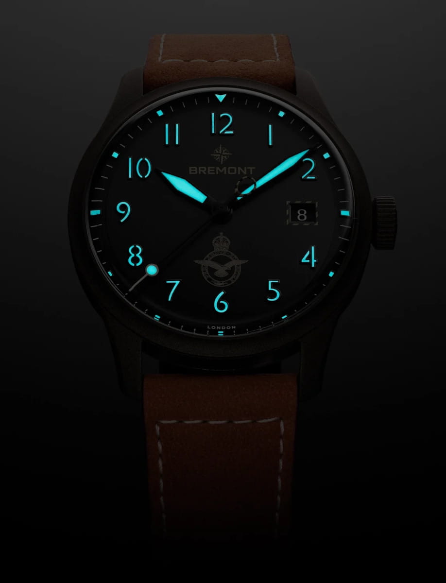 Night view of Bremont HMAF Altitude wristwatch with 904L Stainless Steel Trip-Tick case construction Coated With Cerakote Midnight Bronze, Black Galvanic metal dial, and Light Brown Nubuck Leather Strap.