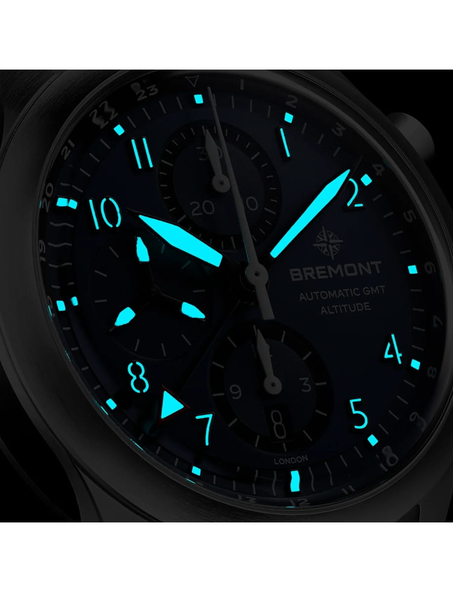 Night view of Bremont wristwatch with stainless steel case and bracelet and blue dial