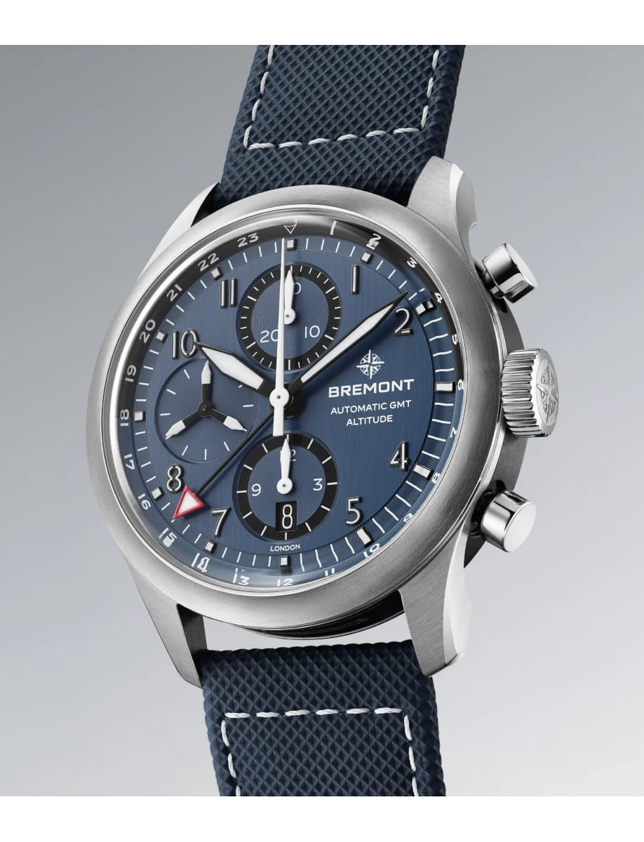 Side view of Bremont wristwatch with stainless steel case, blue dial, blue rubber and leather strap