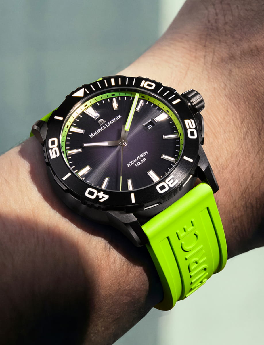 Lifestyle view of Maurice Lacroix Pontos S Solar wristwatch with stainless steel case, black smoked translucid dial, and Green fluo rubber FKM strap with Maurice Lacroix debossed.