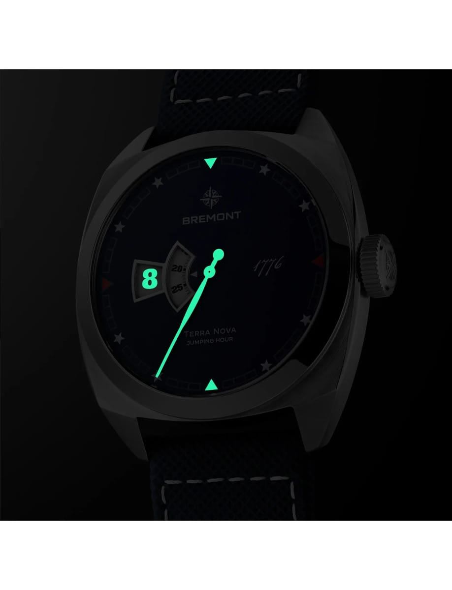 Night view of Bremont Terra Nova 40.5mm Jumping Hour 1776 wristwatch with stainless steel case, blue textured dial, and blue embossed leather strap.