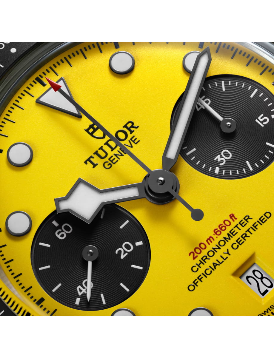 Close view of Tudor wristwatch with stainless steel case and bracelet and yellow dial