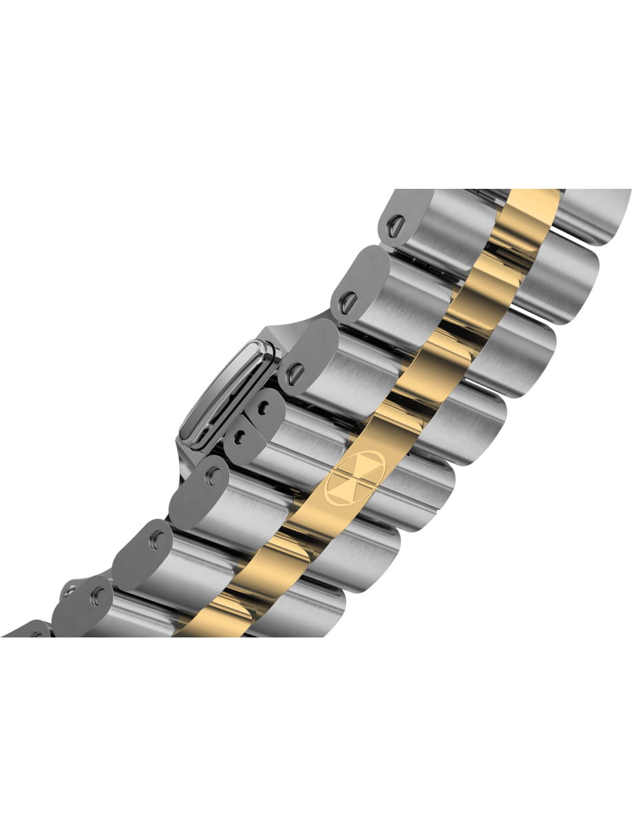 Close-up of a two-tone metal watch bracelet with gold center links; a small radiation symbol is etched on one link.
