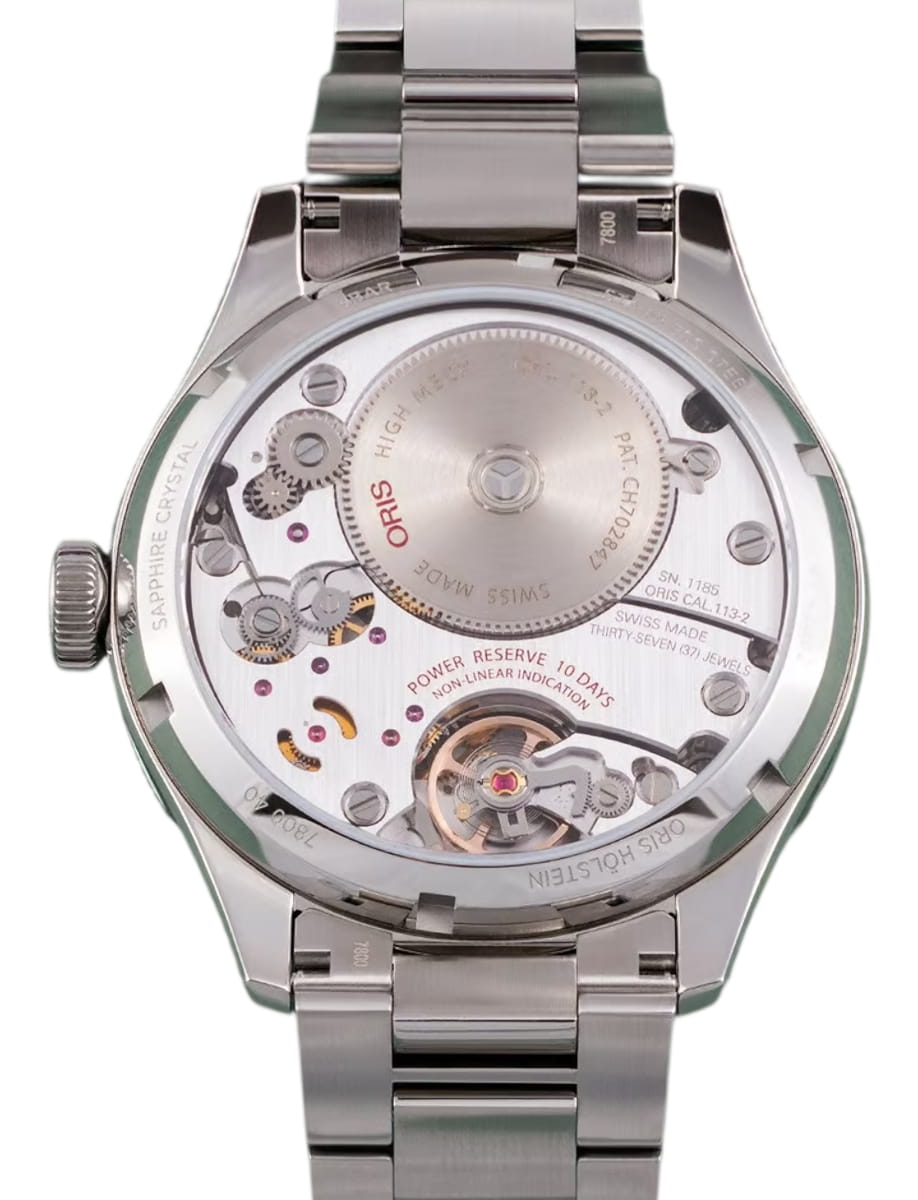Stainless steel wristwatch viewed from the back, showing the exposed mechanical movement with gears and rotor on display.