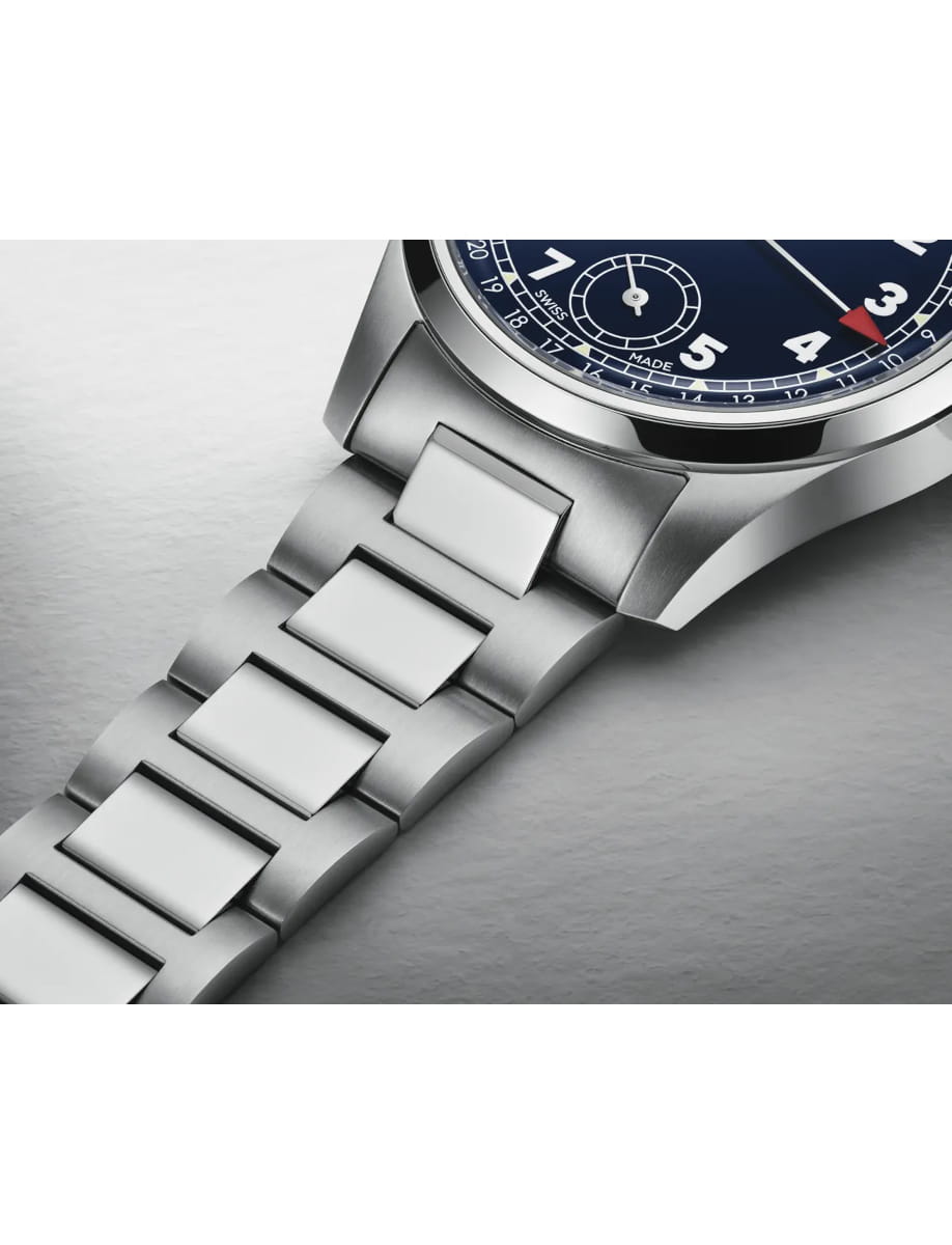 Close-up of a silver stainless steel wristwatch with a blue dial and metal link bracelet