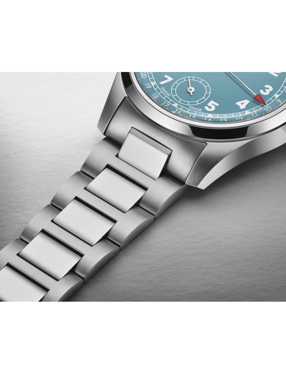 Close-up of a stainless steel wristwatch with a blue dial and linked bracelet