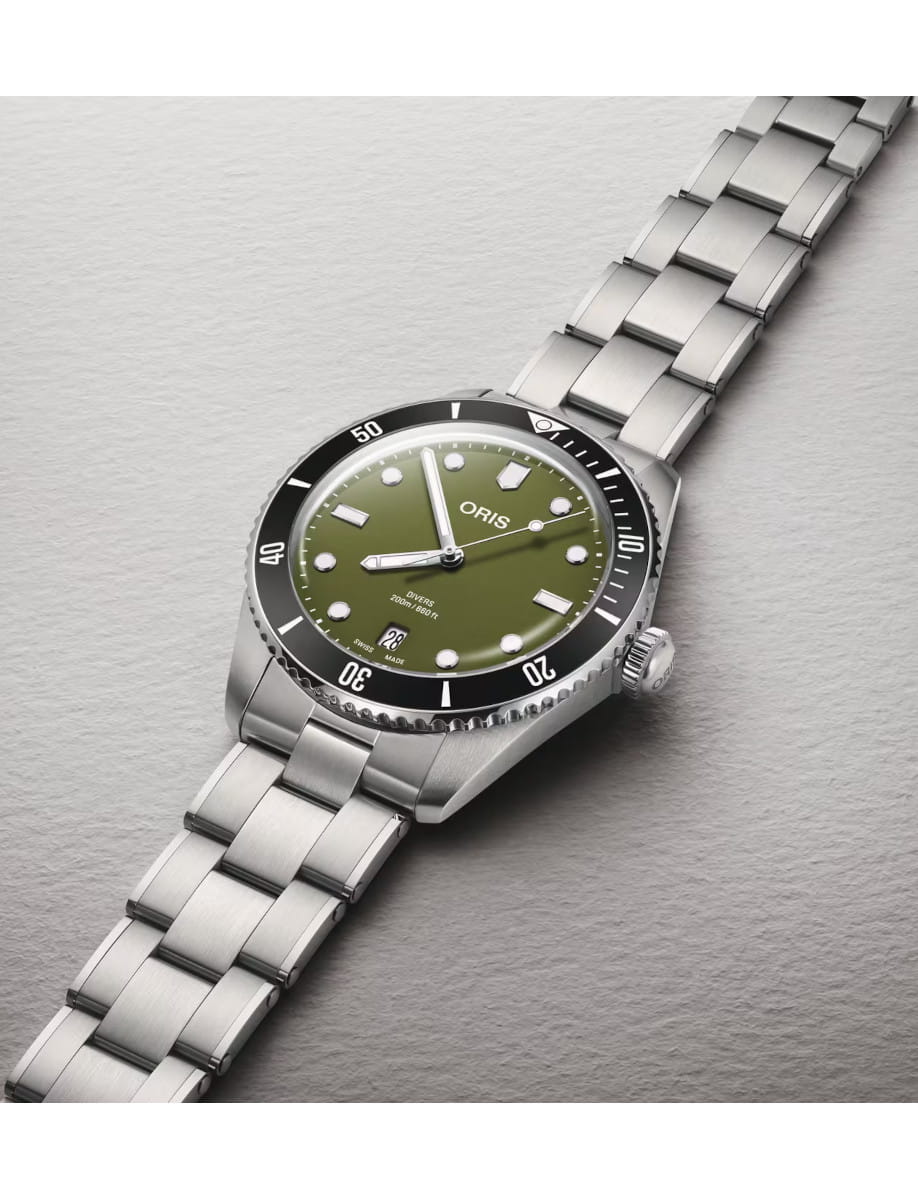 Side view of Oris Divers Date wristwatch with stainless steel case and bracelet, and olive green dial.
