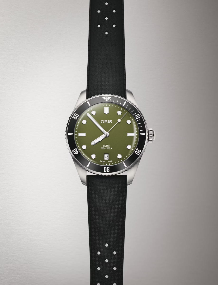 Front view of Oris Divers Date wristwatch with stainless steel case, olive green dial, and black rubber strap.