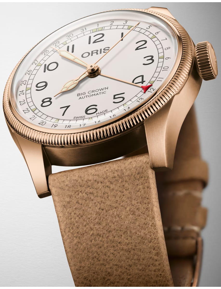 Close-up of a rose-gold Oris Big Crown wristwatch with a white dial and tan leather strap.