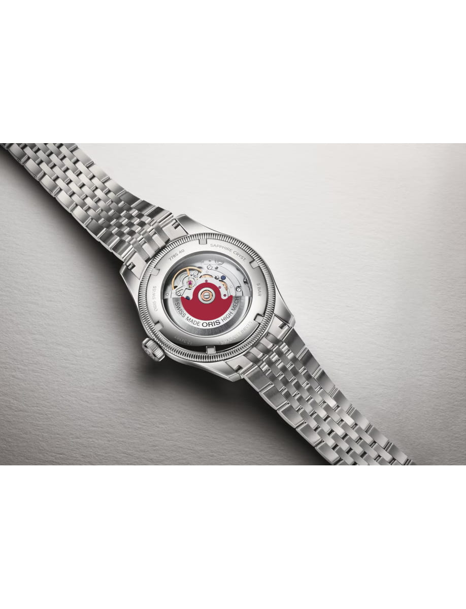 Stainless steel wristwatch with a transparent case back showing the mechanical movement inside