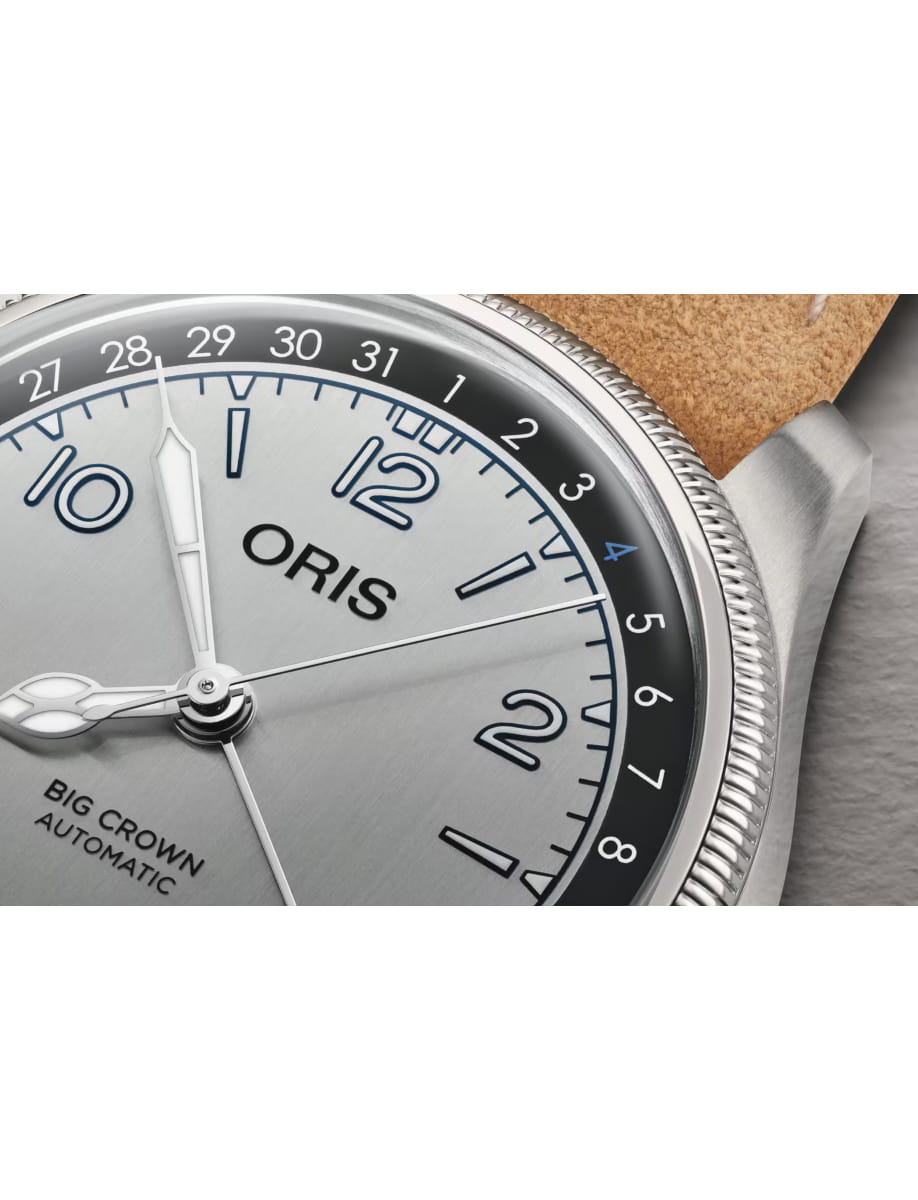 Close-up of an Oris Big Crown Automatic wristwatch with a silver dial, blue numerals, and textured bezel.