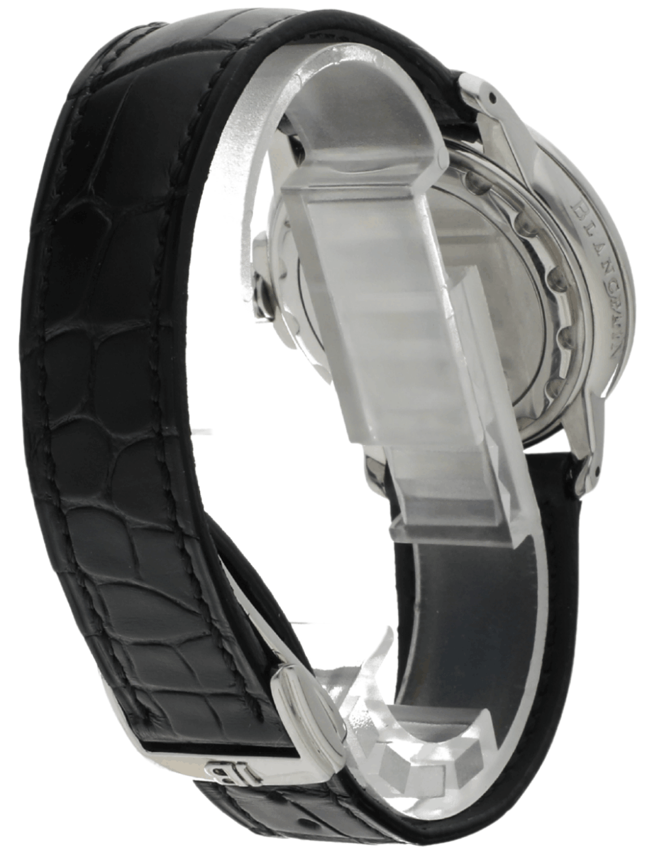Side view of a stainless steel watch with a black textured leather strap and deployment clasp, showing the case back.
