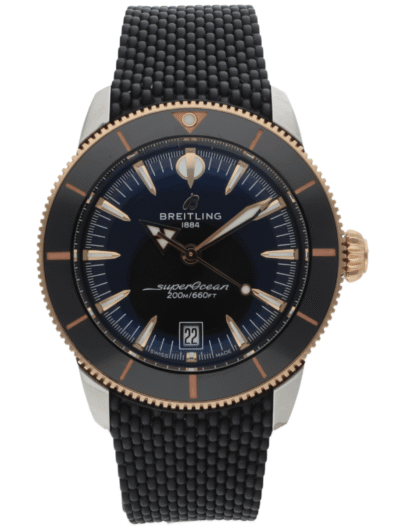 Breitling SuperOcean diver's watch with blue dial, rose-gold bezel, black textured strap, and date window at 6 o'clock showing 22