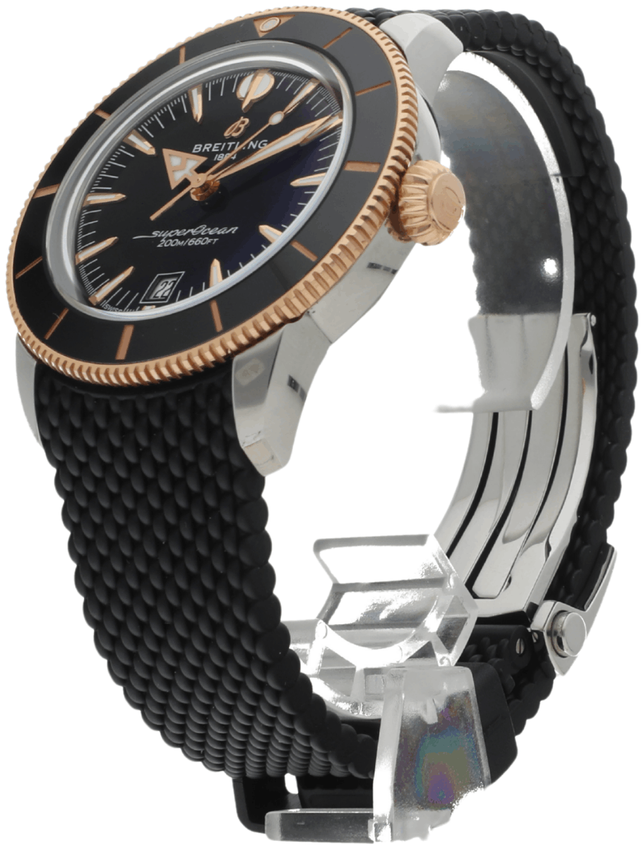 Breitling Superocean wristwatch with black strap and gold bezel, angled to show dial details
