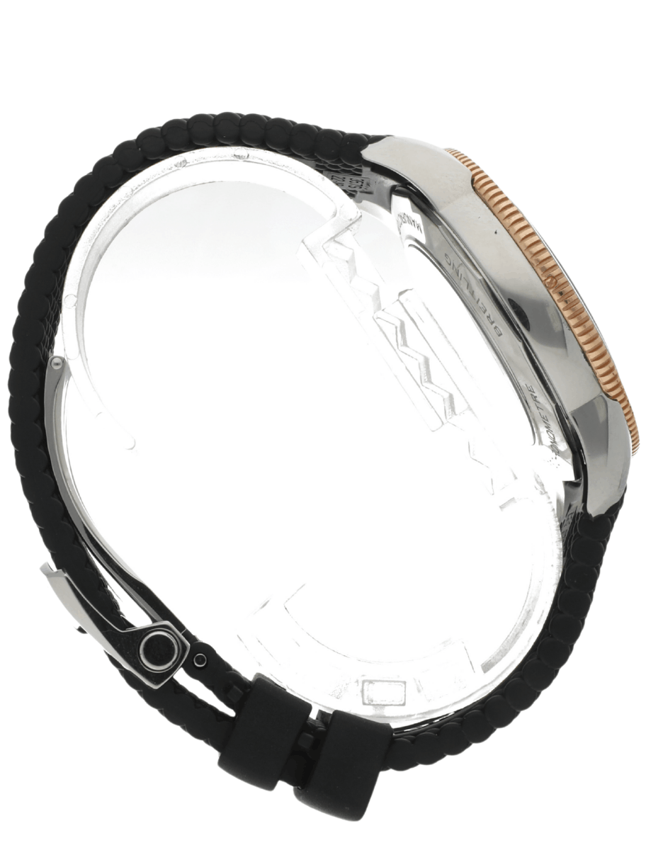 Side view of a wristwatch with a black beaded strap, silver case, and gold-toned bezel showing the watch profile and clasp.