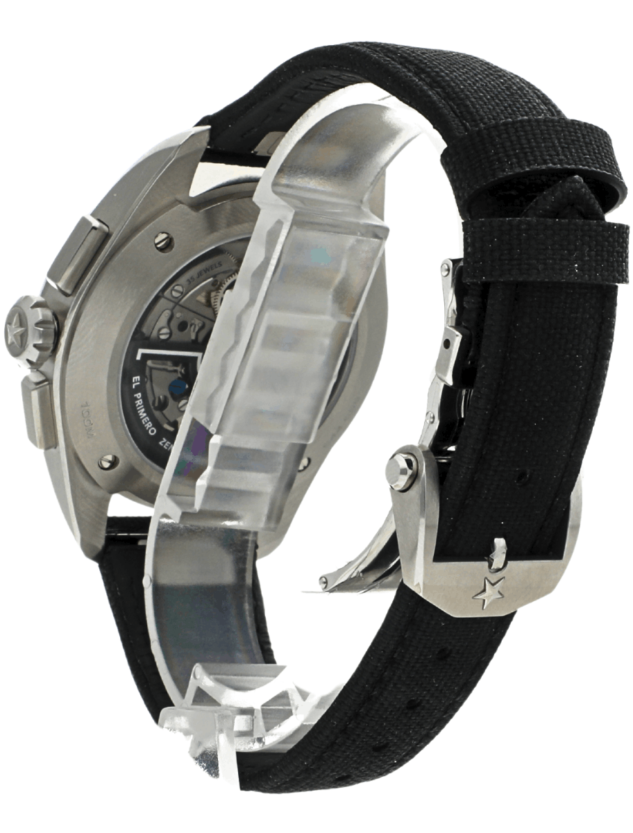 Watch with black fabric strap and stainless steel case; transparent back reveals the automatic movement inside the mechanism.