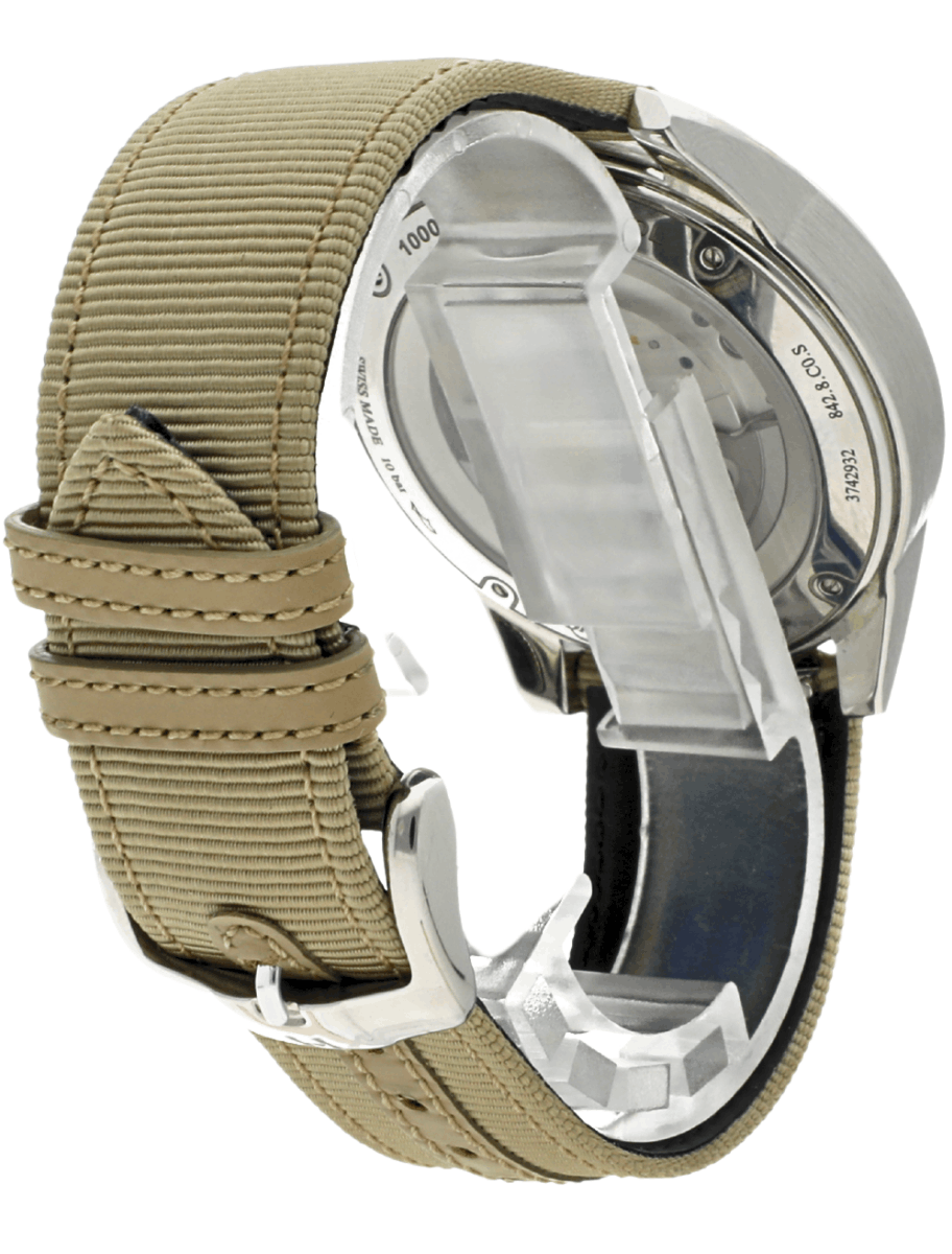 Wristwatch with a beige fabric strap and metallic case shown from the side, with the deployment clasp partially open.