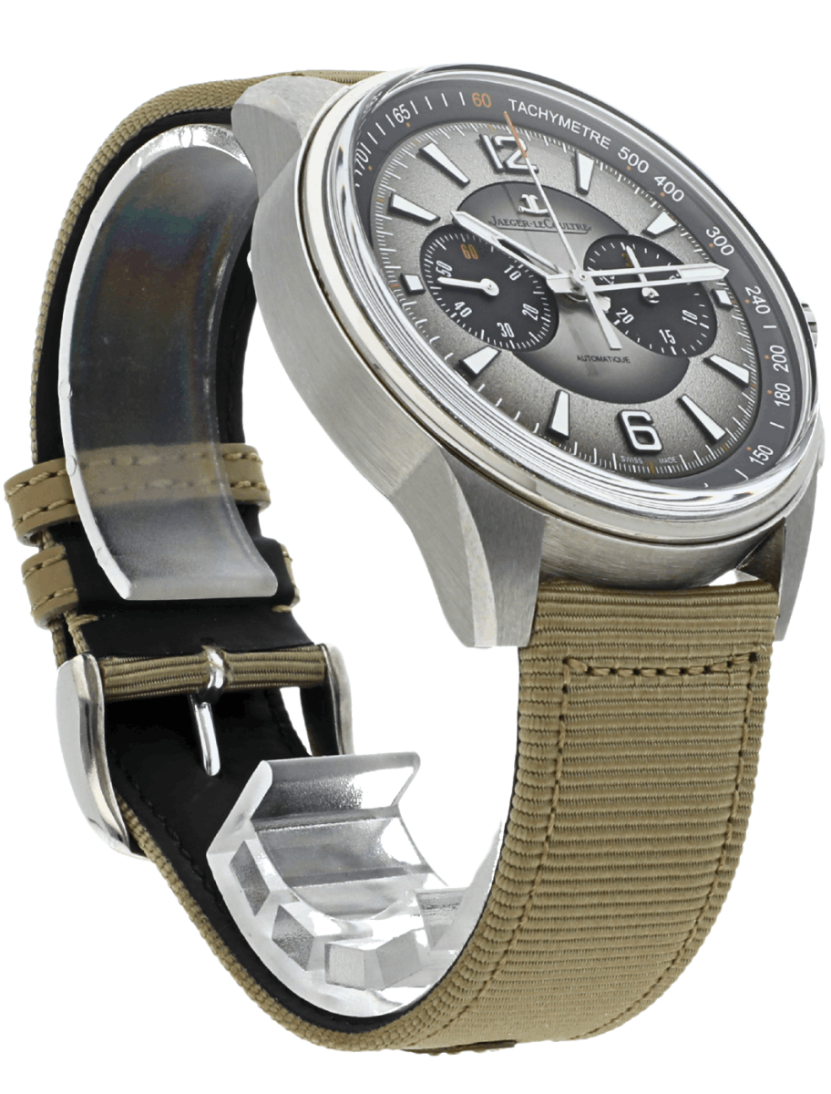 Analog wristwatch with a silver dial, three subdials, and a tachymeter bezel, paired with a tan fabric strap.